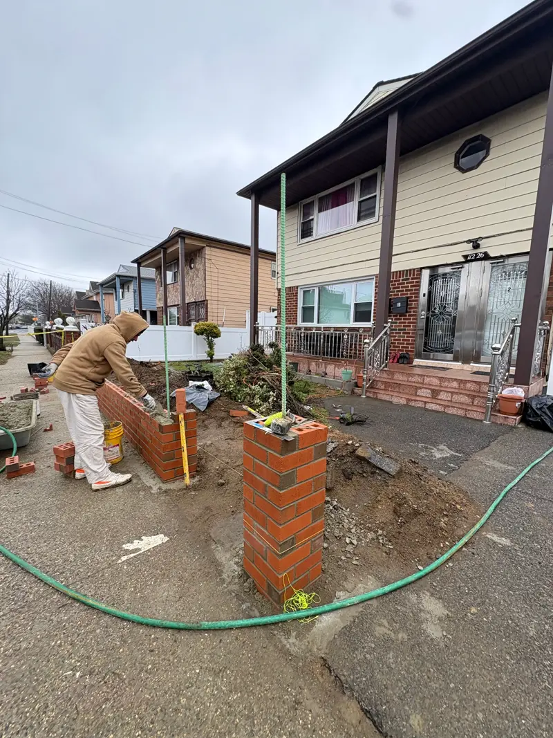 Mason building brick pillar and retaining wall at a Queens residential property