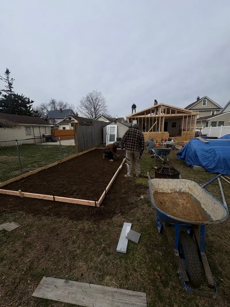 Workers preparing foundation and framing for a new structure in Nassau County