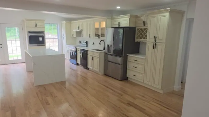 Open-concept kitchen remodel with quartz island, custom cabinetry, and hardwood floors