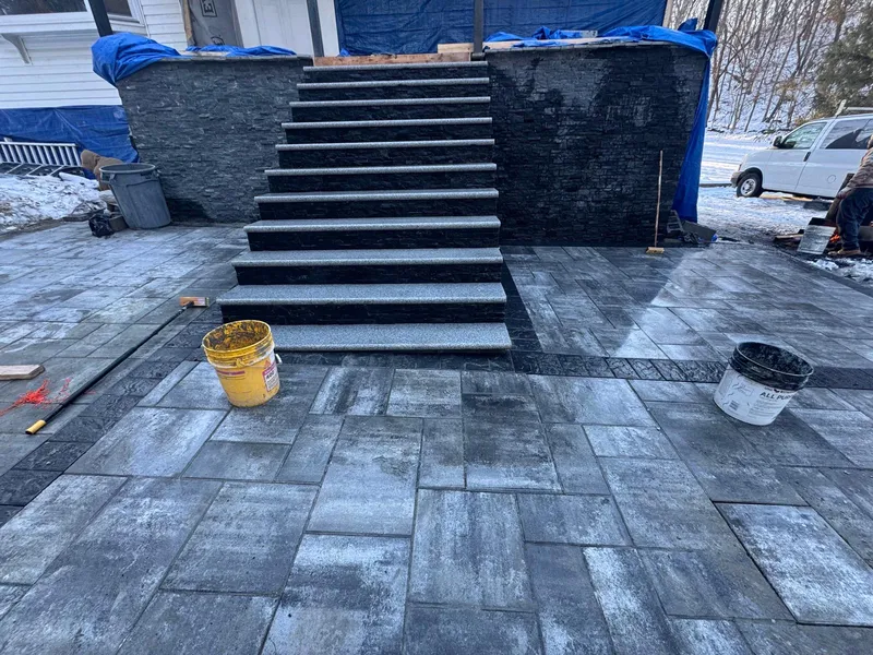 Reflective coating being applied to a flat roof in the Bronx